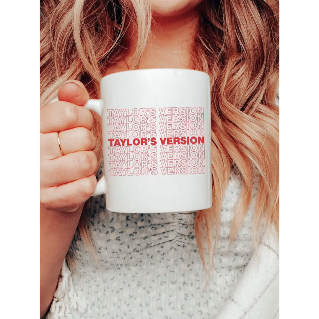 White mug with red and white outline text "Taylor's Version". Taylor's Version - Pop Music Coffee Mug is printed in North Carolina. It is top-rack dishwasher safe and has a double-sided print.