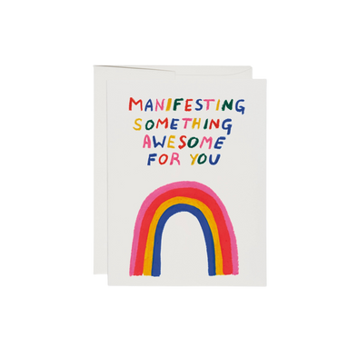 Illustrated rainbow with rainbow colored text reading "Manifesting Something Awesome For You". This Something Awesome Encouragement Card has a blank interior, is printed on 100lb heavyweight card stock, and features an offset printed design. At 5.5 x 4.25 inches, it is illustrated by Katie Benn and printed in the USA on recycled paper.