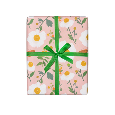 White flowers with green stems on a pink background. Sheet - Single (1) 19 x 27 inch sheet   Roll - Three (3) 19 x 27 inch sheets of flat wrap, rolled and sealed together.   Illustrated by Kate Pugsley. Printed in USA, on recycled paper.