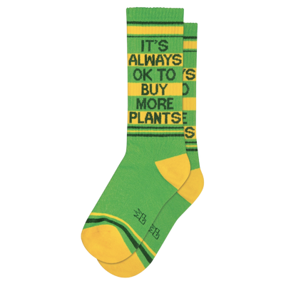 Green socks with yellow and dark green stripes and text "It's Always Ok To Buy More Plants". No space is off-limits when it comes to adding plants. From bathrooms to bedrooms, from basements to kitchens, and even offices, you can never go wrong with a new plant. It's Always OK To Buy More Plants Ribbed Gym Socks are made from a durable blend of 61% Cotton, 36% Nylon, 3% Spandex and are designed to fit most people. Made in the USA.
