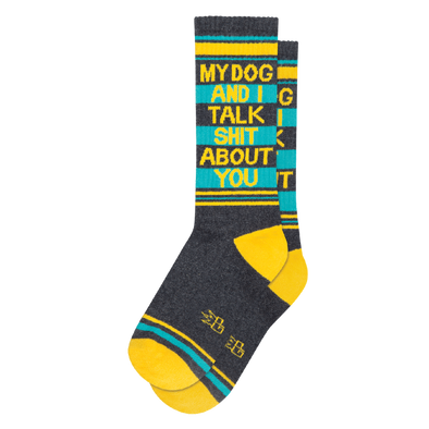 Grey socks with yellow and teal stripes and text "My Dog And I Talk Shit About You". Dog owners need not worry, as their four-legged friends are trusted to keep secrets better than their human counterparts. My Dog and I Talk Shit About You Socks provide a convenient one-size-fits-most, unisex design crafted with a blend of 65% Cotton, 32% Nylon, and 3% Spandex, all proudly made in the USA.