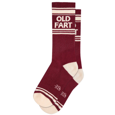Maroon socks with white stripes and text "Old Fart". Not a day over magnificent? Sport some Werther's Original confection, plus these outrageous show-stoppers crafted from a comfy blend of 61% cotton, 36% nylon, and 3% spandex awesomeness. A proud single-size, made in USA, fit for a true OLD FART!